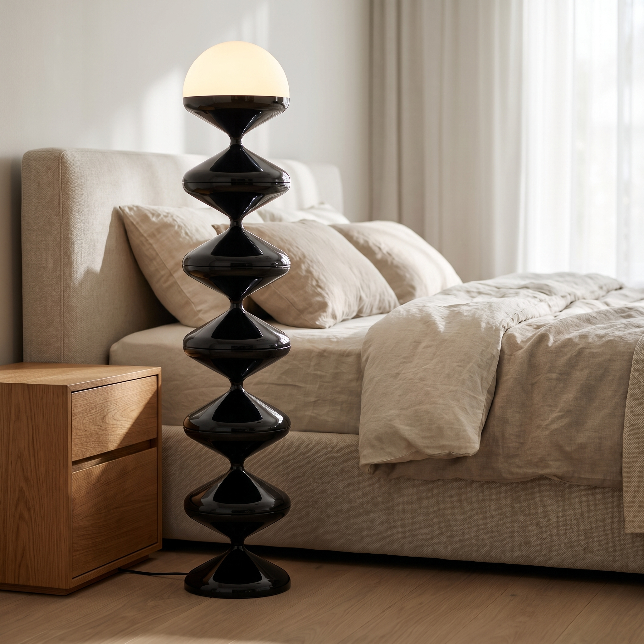 Black sculptural floor lamp beside a bed in a bright modern bedroom