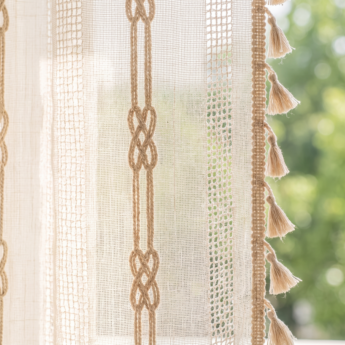 Brezza curtain detail: braided cord band, open weave and tassel edge