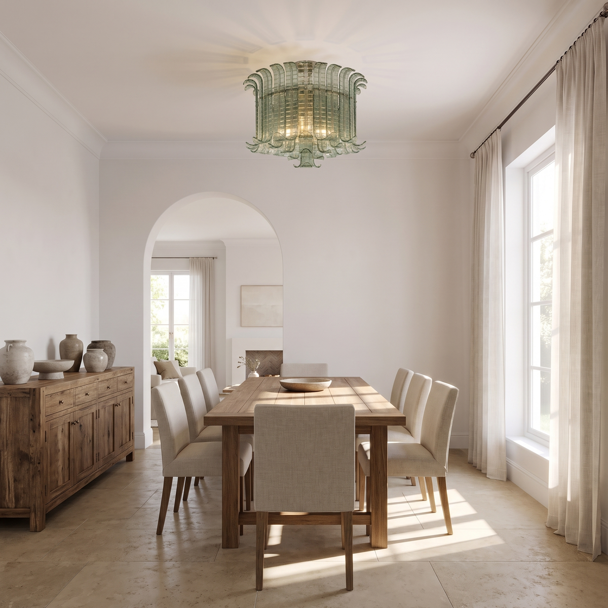Green glass leaf flush mount chandelier above an oak dining table
