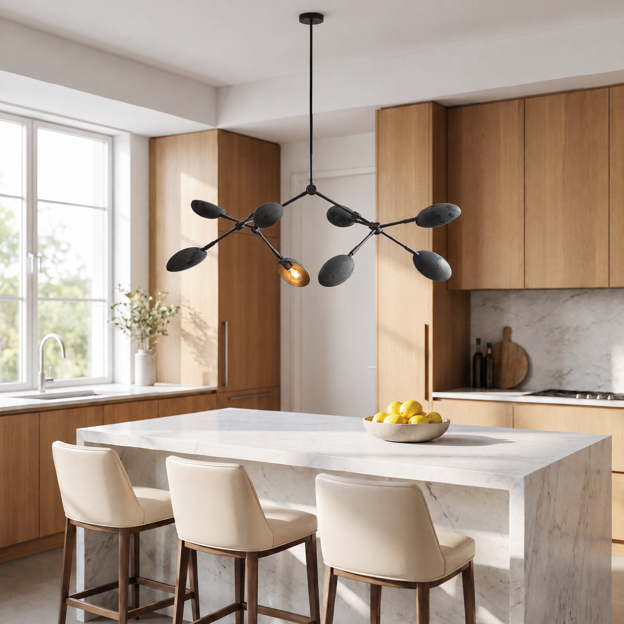 Ramo Goccia oxidized branch chandelier above a marble kitchen island