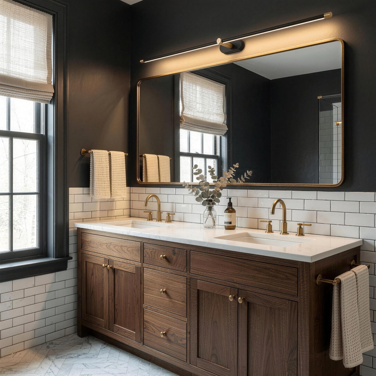 Cordless LED light above a vanity mirror in a dark navy bathroom