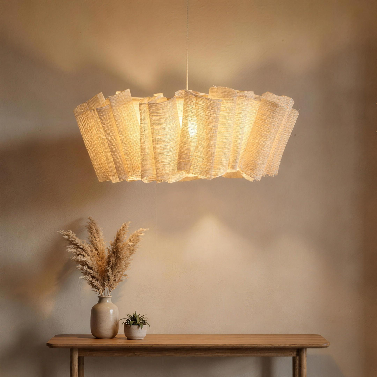 Woven abaca pendant glowing above a console with dried grasses
