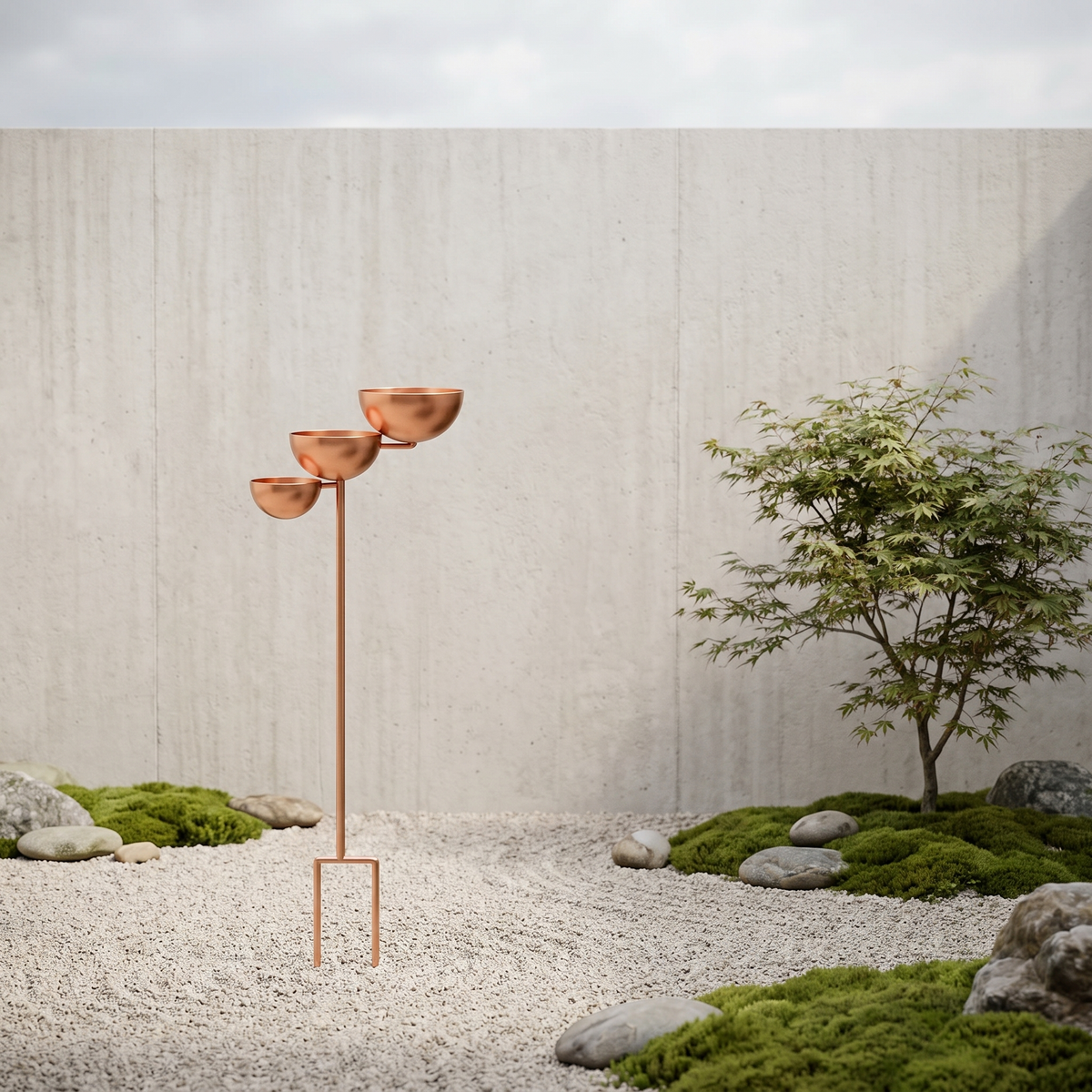 Copper bird bath in a minimalist gravel courtyard with a Japanese maple