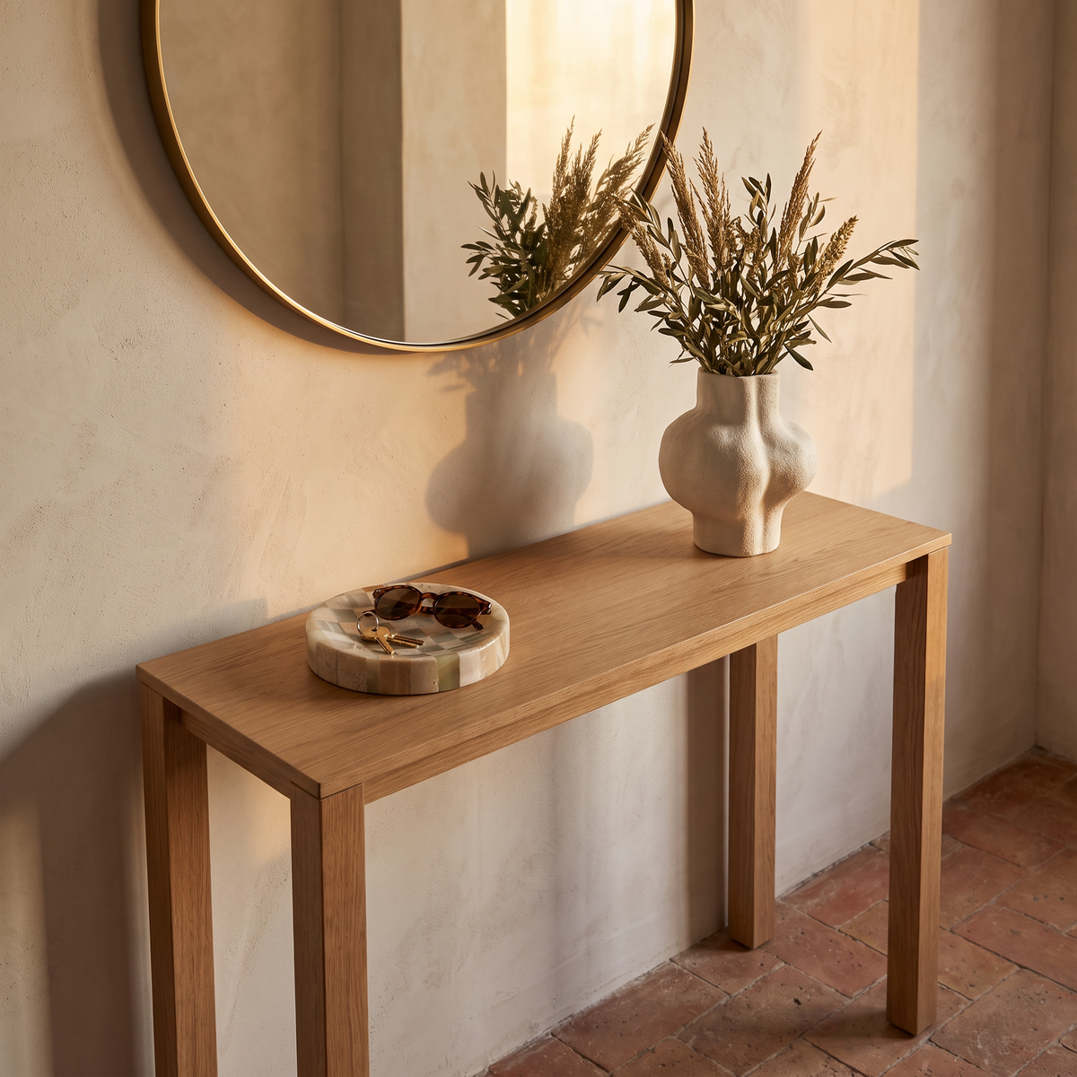 Olvera trinket dish catching keys on an oak entryway console