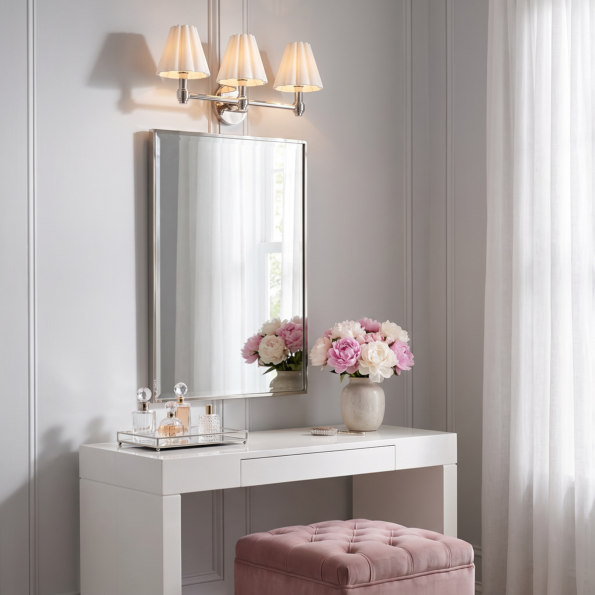 Terzetto polished nickel sconce with fluted shades above a dressing table mirror