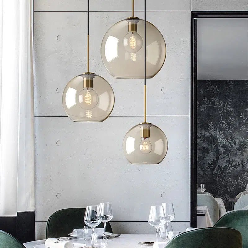 Ambra cognac glass pendants above an elegant set dining table