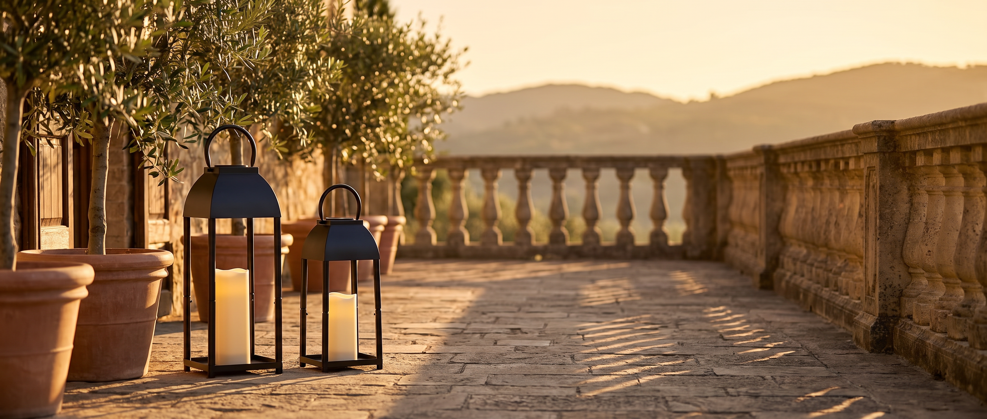 Black candle lanterns on a Mediterranean terrace at golden hour