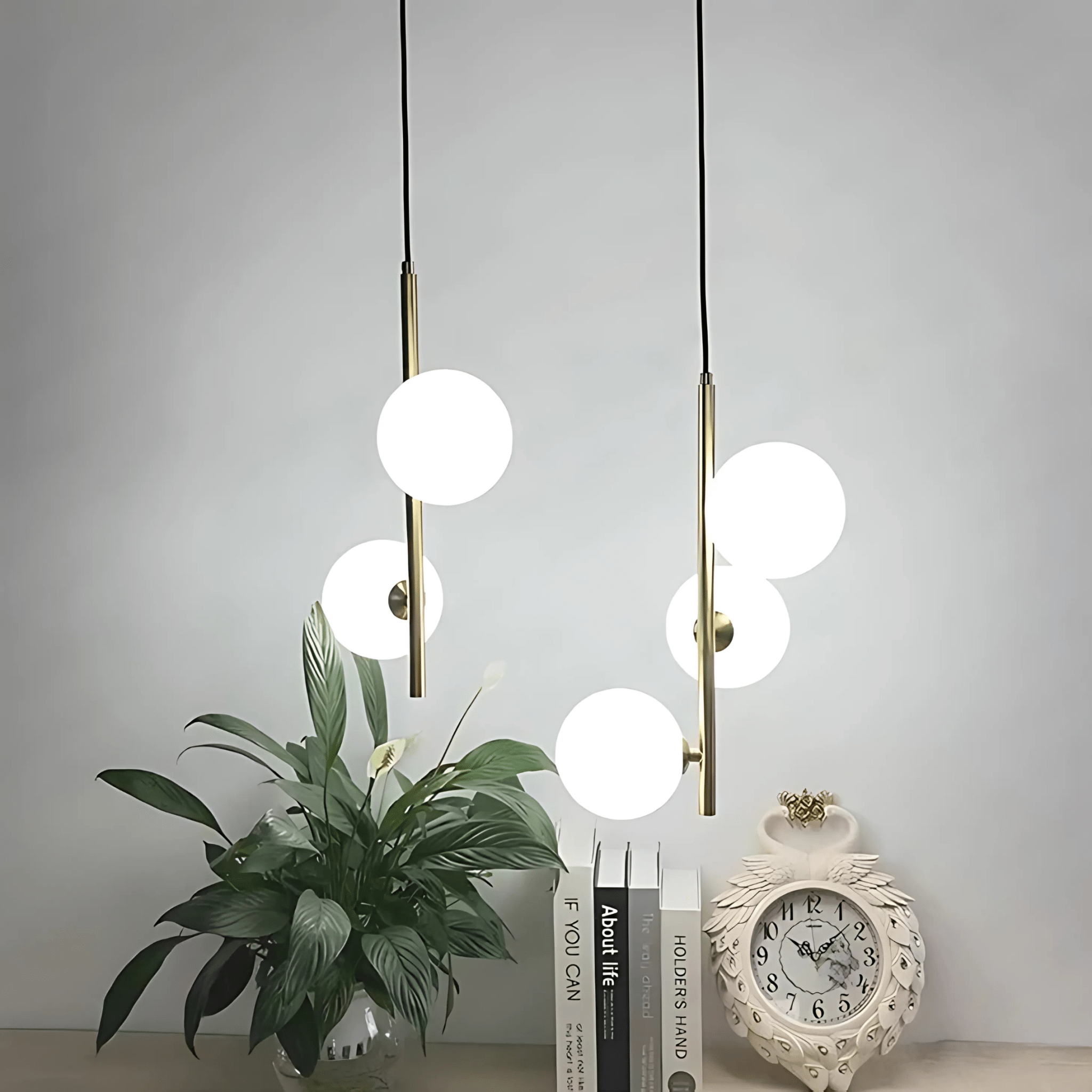 Brass Perla Opal Globe Pendant styled with greenery and books