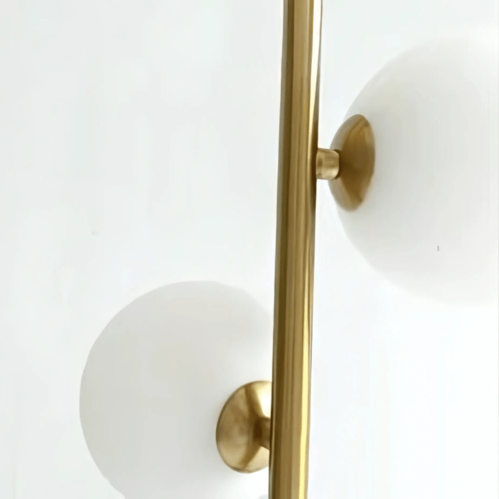Detail of the brass stem and globe of the Perla Opal Globe Pendant