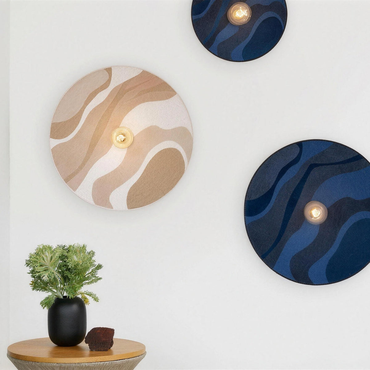 Luna Tessuta wall sconces in Sand Waves and Midnight Blue Waves on a white wall
