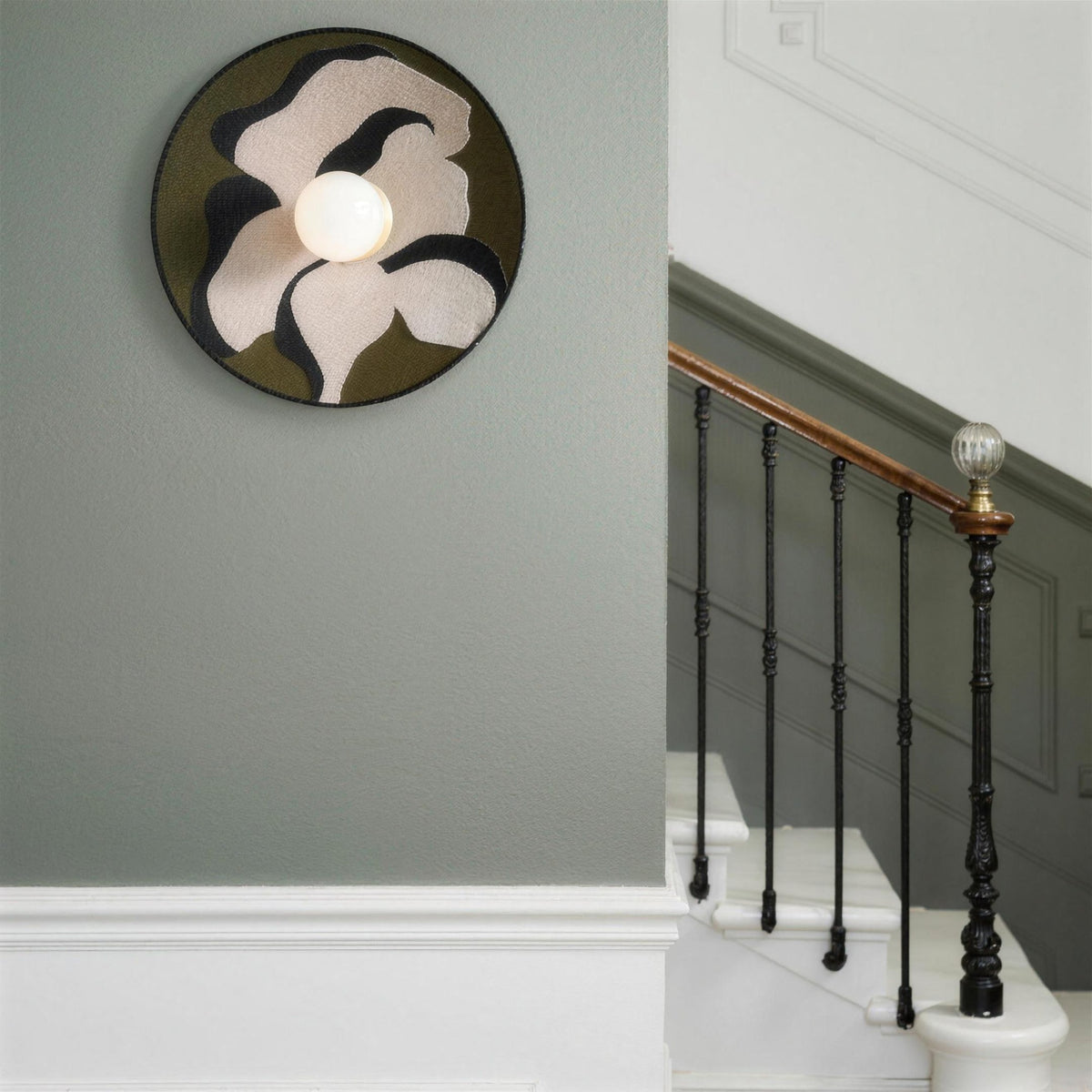 Luna Tessuta wall sconce in Khaki Bloom on a sage stair landing