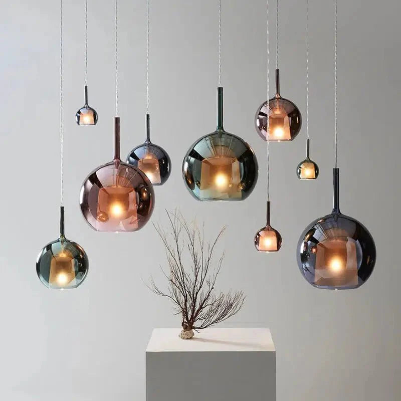 Cluster of Luna Glass Globe Pendants in mixed tints on a white wall