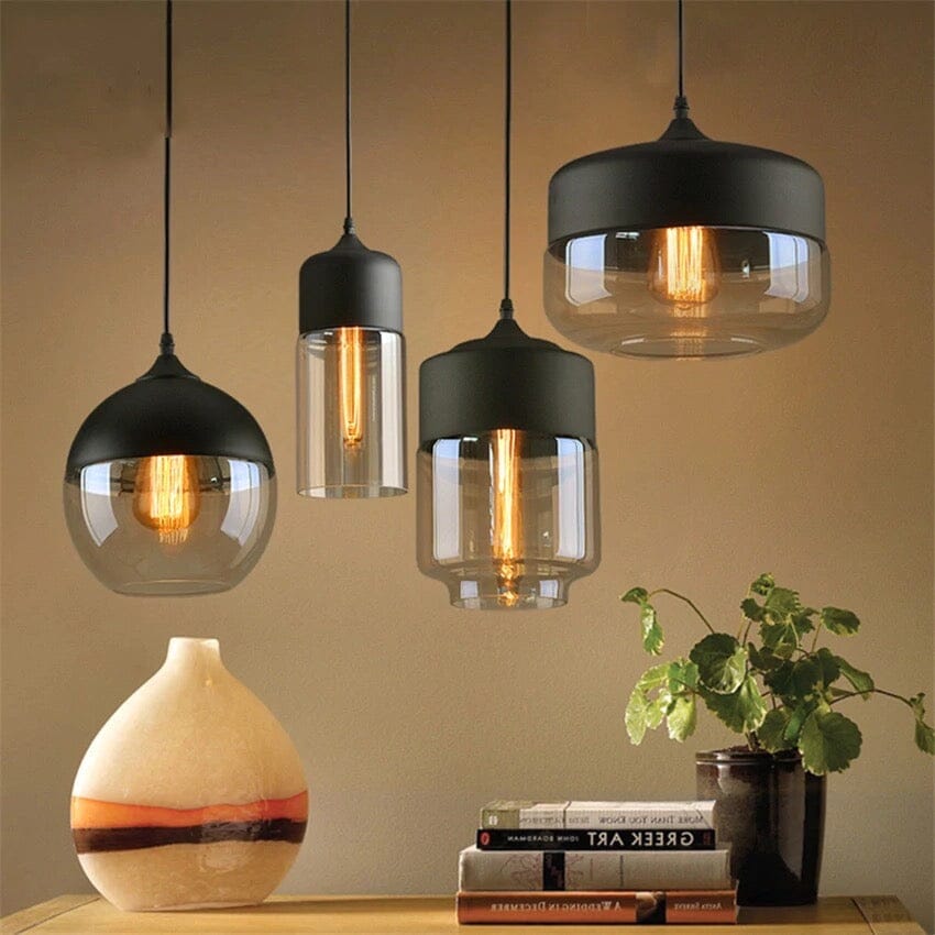 A collected set of Ambra Art-Glass Pendants above a styled sideboard