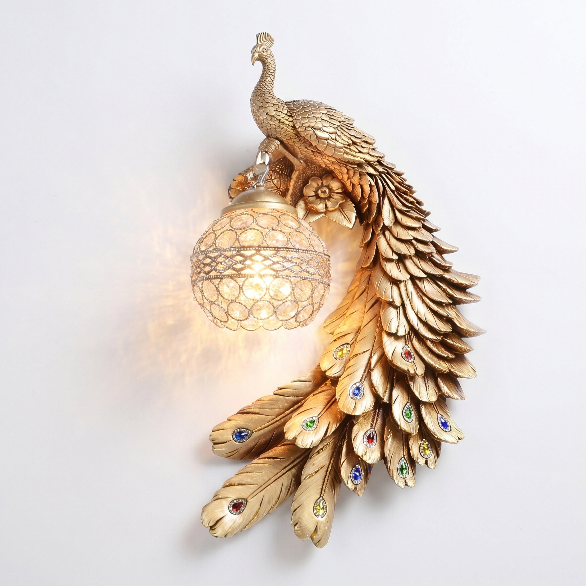 Pavone gold peacock crystal wall sconce, right facing, crystal ball lit