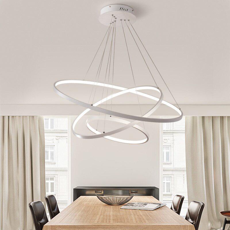 White LED ring chandelier above a dining table