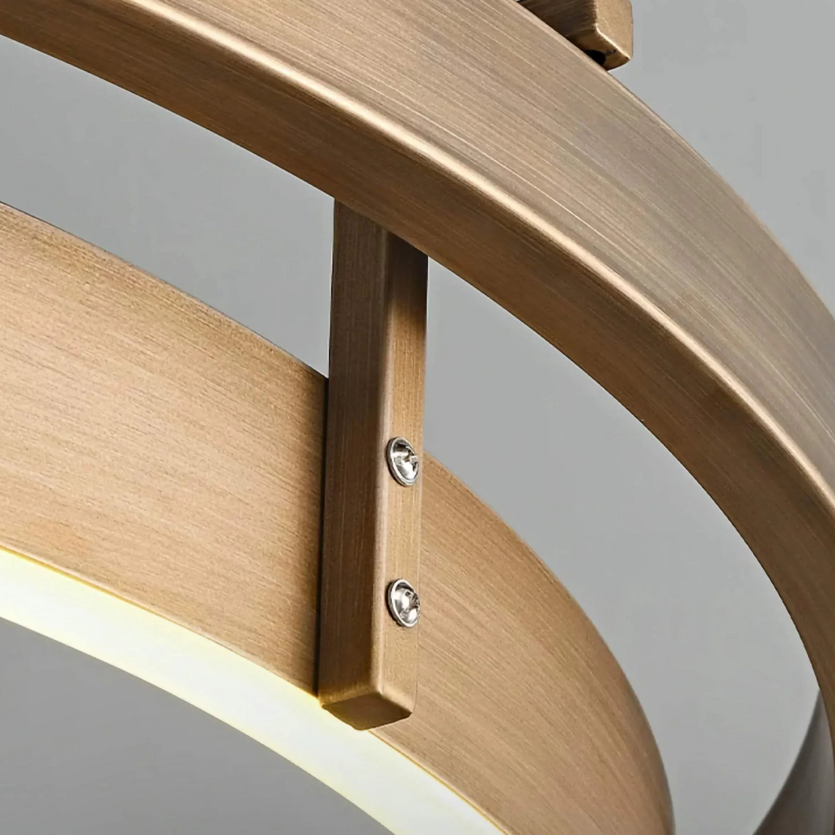 Close-up of the brushed brass ring band and vertical brass post of the double ring chandelier