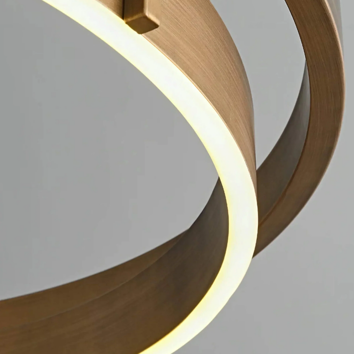 Detail of the warm 2700K LED line glowing along the edge of the brushed brass ring