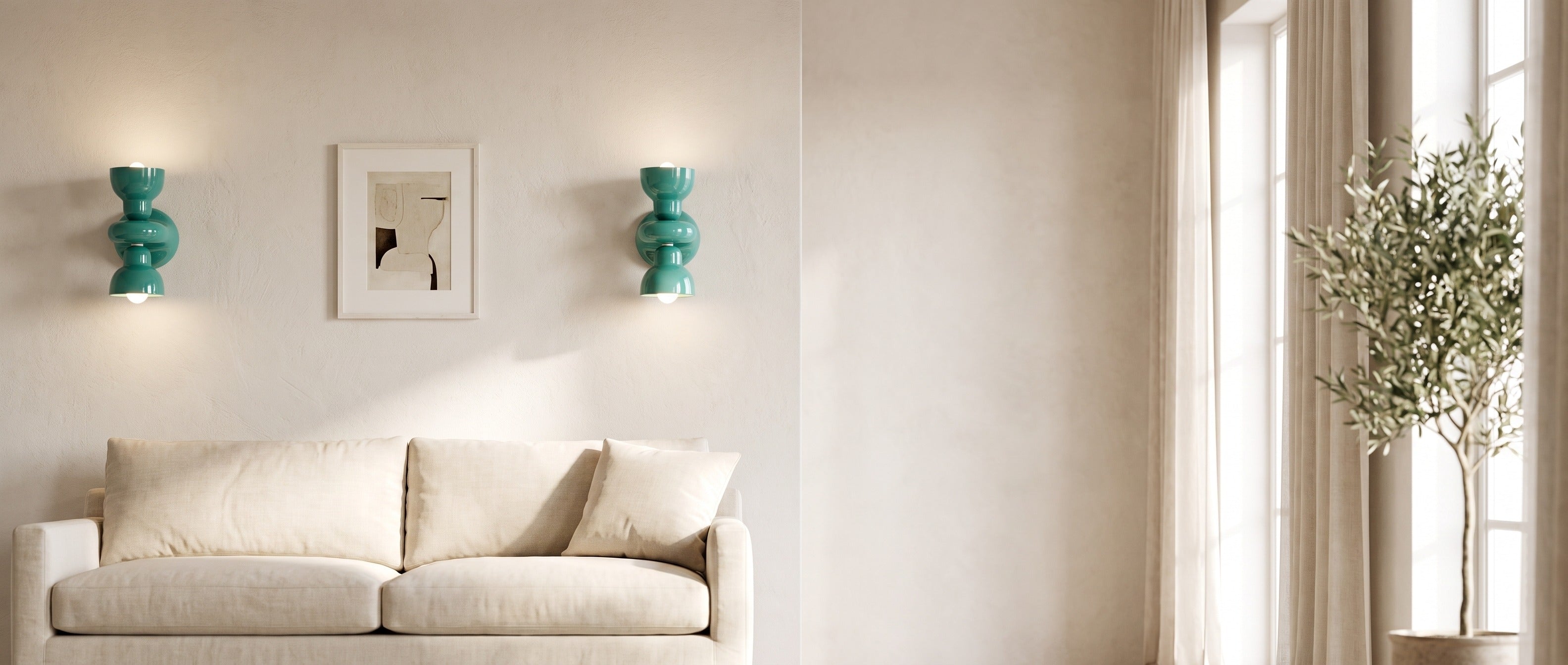 Turquoise ceramic wall sconces flanking artwork above a sofa