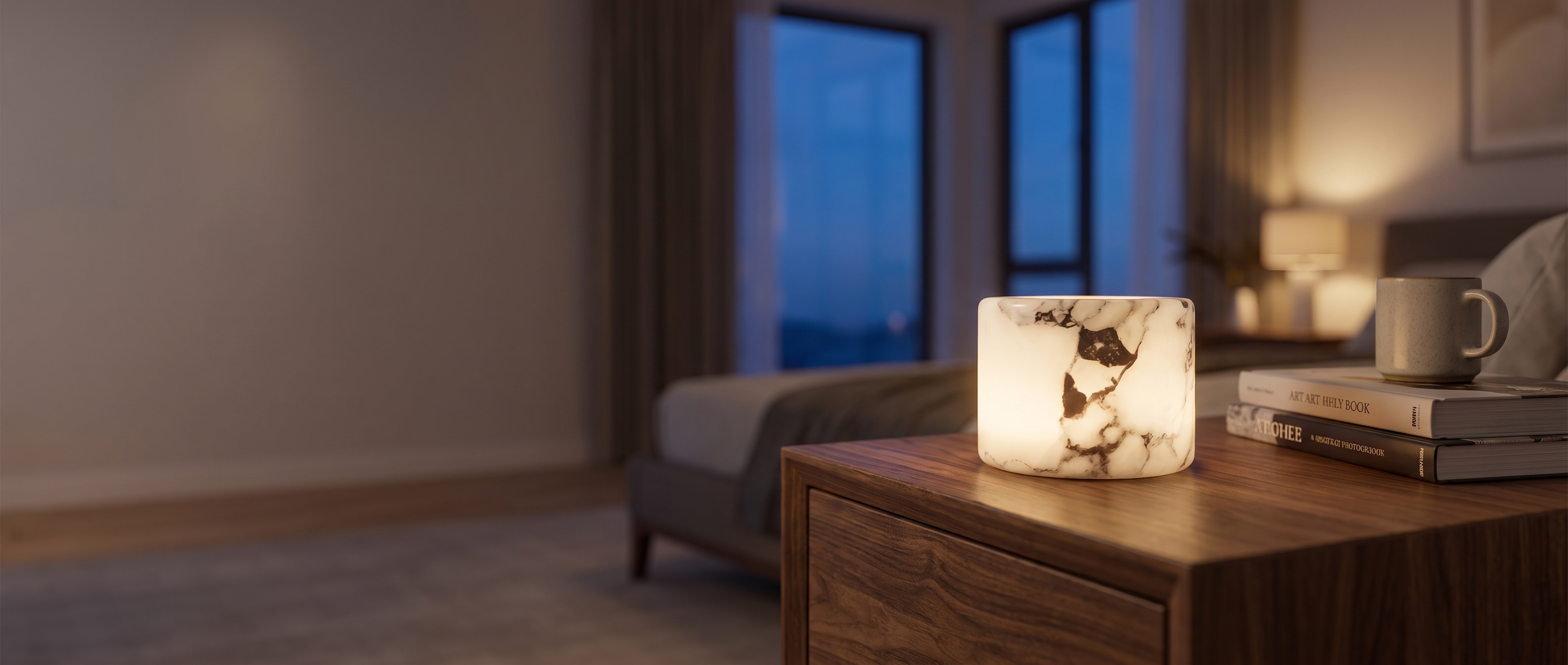 Pietra Lunare marble mood lamp glowing on a walnut nightstand at dusk