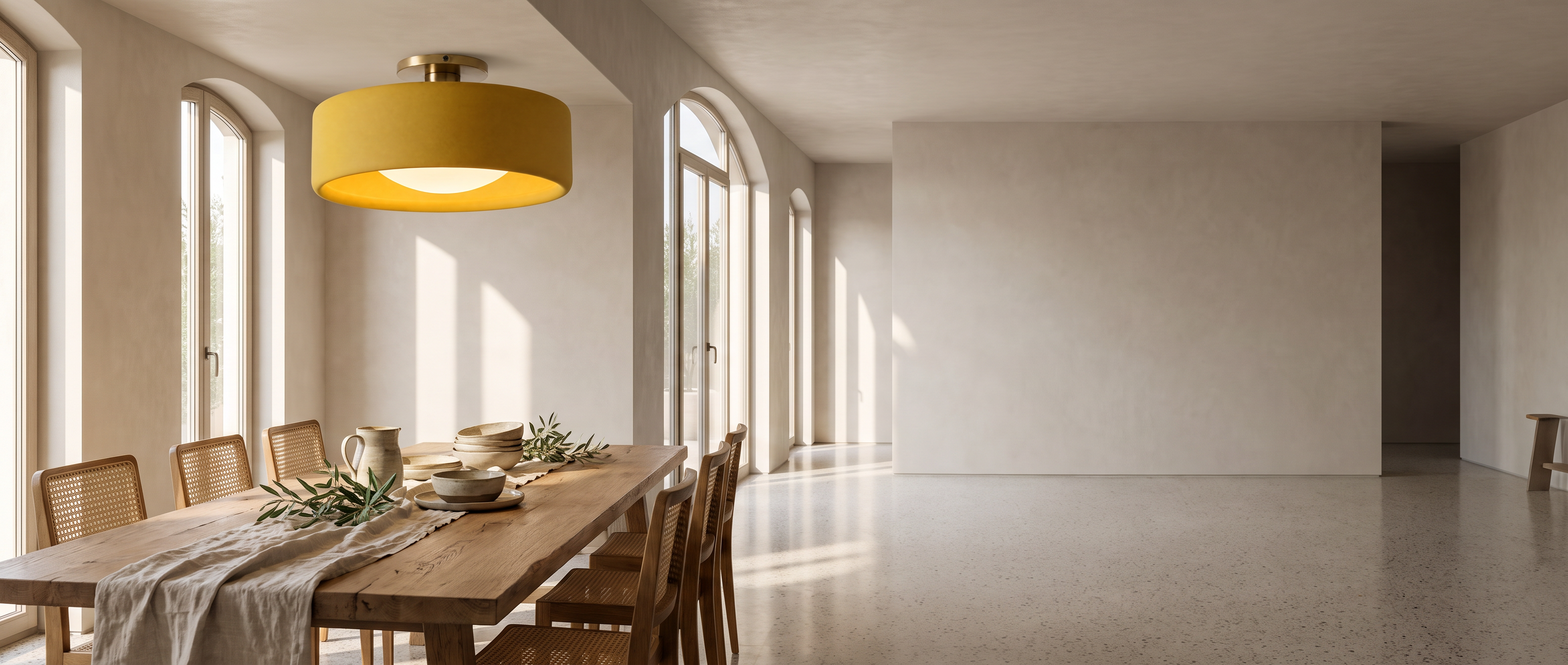 Yellow porcelain semi-flush ceiling light above a sunlit Italian dining table